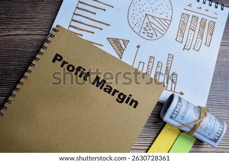 Concept of profit margin and chart write on book isolated on Wooden Table.
