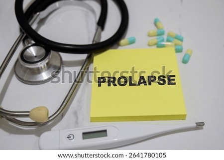Concept of Prolapse write on sticky notes isolated on Wooden Table. stethoscope and pharmaceuticals