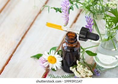 Concept Of Pure Natural Organic Herbal And Flower Ingredients In Cosmetic Production. Camomile, Lavender Essential Oils For Gentle Face And Body Care. Aromatherapy. Wooden Background, Copy Space