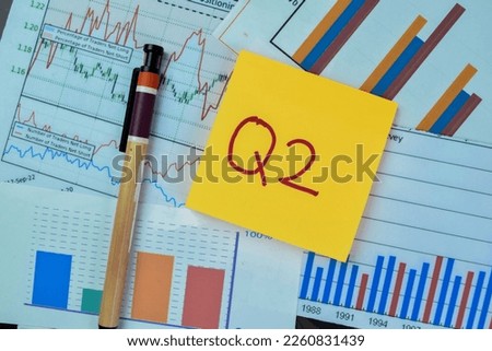 Concept of Q2 - 2nd Quarter Period write on sticky notes isolated on Wooden Table.