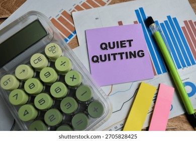 Concept of quiet quitting write on sticky notes isolated on Wooden Table.