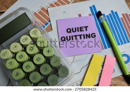 Concept of quiet quitting write on sticky notes isolated on Wooden Table.