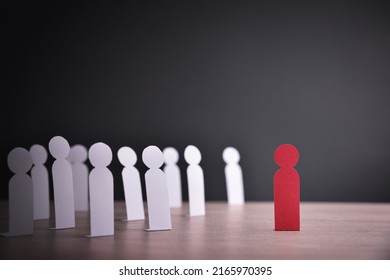Concept of racial exclusion with cutouts of people of one color grouped discriminating against another person of another color. Front view - Shutterstock ID 2165970395