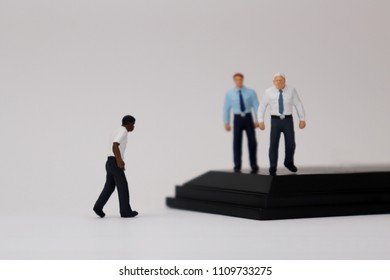 The Concept Of Racism In Business. Miniature people of different races.