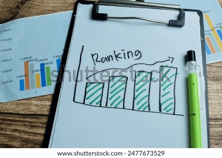 Concept of Ranking with graph write on paperwork isolated on wooden background.