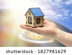 The concept of real estate mortgages, citizenship and accommodation. In hands holding a model of a wooden house against the background of the flag of State of Louisiana.