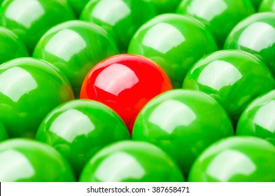 Concept With Red And Green Marbles -  Being Different