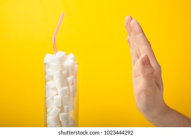 Concept Of Refusing To Eat Sugar, A Stop Sign On A Yellow Background.