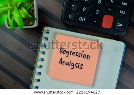 Concept of Regression Analysis write on sticky notes isolated on Wooden Table. Selective focus on regression analysis text