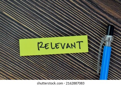 Concept of Relevant write on sticky notes isolated on Wooden Table.