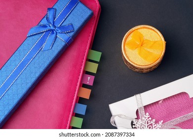 The concept of a reminder of the gift. Diary with colored bookmarks and an exclamation mark. Next to the gift boxes