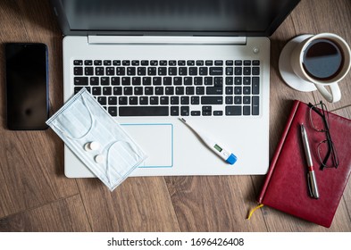 The concept of remote work during the coronavirus epidemic. Woman working on laptop at home in disposable gloves and mask.