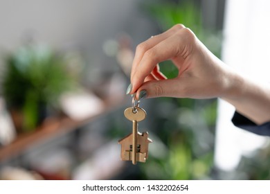 Concept Of Renting An Apartment. House Key In Womans Hands. Young Woman. Modern Light Lobby Interior. Real Estate, Hypothec, Moving Home Or Renting Property.