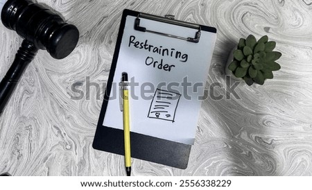 Concept of Restraining Order write on paperwork isolated on Wooden Table.