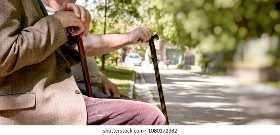 Concept of a retirement age - pensioners, friends sitting in the park and resting - Shutterstock ID 1080172382