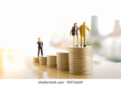 Concept of retirement planning. Miniature people: Old couple figure standing on top of coin stack. - Shutterstock ID 705716659
