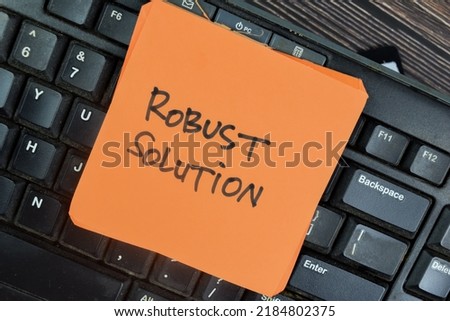 Concept of Robust Solution write on sticky notes isolated on Wooden Table.
