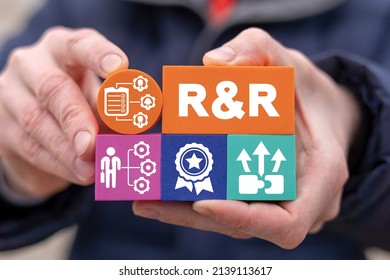 Concept Of Roles And Responsibilities. Businessman Holding Colorful Styrofoam Blocks With R And R Abbreviation And Other Social Business Icons. Employee Role And Responsibility.