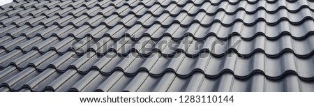 concept for roof housetop icon with grey roofing tiles. banner texture for roofers 商業照片 © 