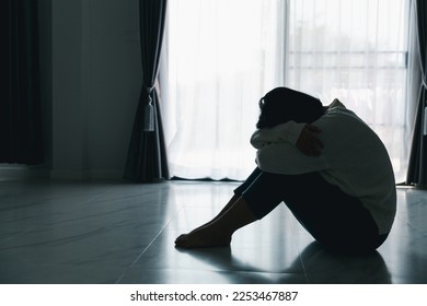 Concept of sad teenage girl depression. Upset teenage girl sitting at floor indoors. Anxiety young woman Despair and stress. Lonely and unhappy female are social victims. loneliness youth in home. - Shutterstock ID 2253467887