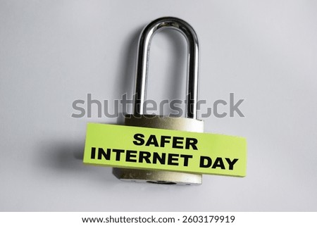 Concept of Safer Internet day write on sticky notes and padlock isolated on Wooden Table.