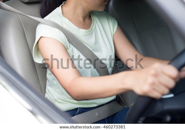 Concept safety asian woman driving a car with seat\
belt on for safety
