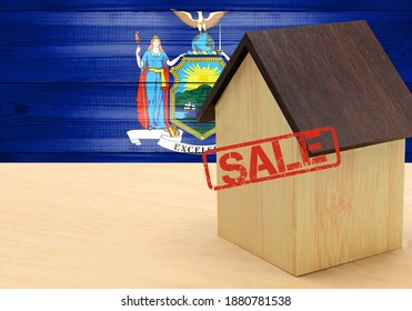 The Concept Sale Of Apartments, Of Real Estate Mortgages, Citizenship And Accommodation, As Well As Investment In A Future Home. State Of New York Flag On Wooden Background.