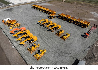 Concept Sale Of Industrial Equipment. Parking With Big Yellow Mining Truck, Bulldozers For Coal Industry, Iron Ore And Gold. Aerial Top View.