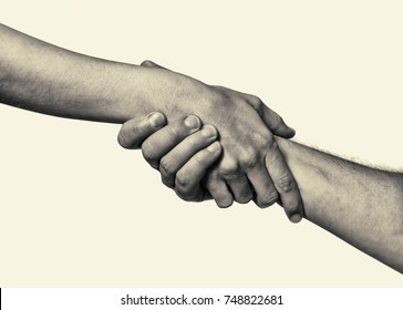 Concept Of Salvation. Black And White Image Of The Hands Of Two People At The Time Of Rescue (help).