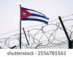 The concept of sanctions pressure on the Cuba government. Cuban flag in barbed wire, sanctions and aggression of Cuba. Cuban prison. US sanctions against Cuba. The Cuban embargo.