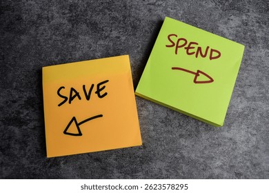 Concept of Save or spend write on sticky notes isolated on Wooden Table.