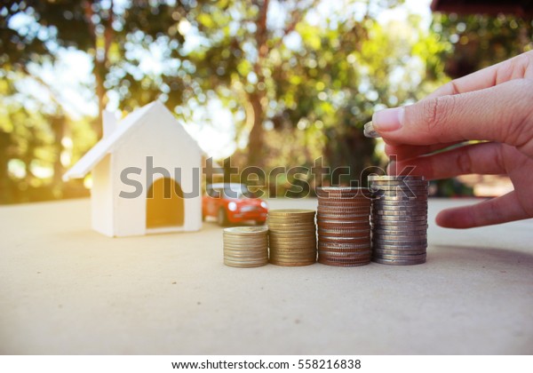 Concept of saving money for house and car, piggy
bank.Business Finance and Money concept,Save money for prepare in
the future.