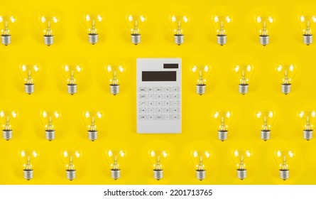 The concept of savings electricity. Reducing the payment of utility bills. A incandescent lamp, calculator on a yellow background. Flat lay, top view