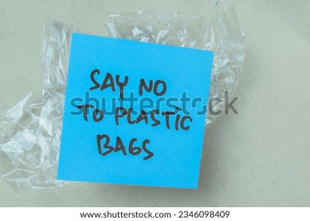 Concept of Say No To Plastic write on book isolated on Wooden Table.
