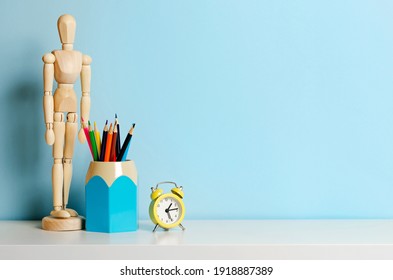 Concept Of School Items On The Home Desk On A Blue Background. Place For Text.