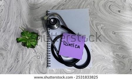 Concept of Sciatica write on sticky notes isolated on Wooden Table.