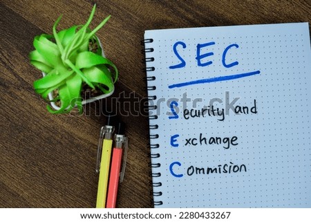 Concept of SEC - Security and Exchange Commision write on book isolated on Wooden Table.