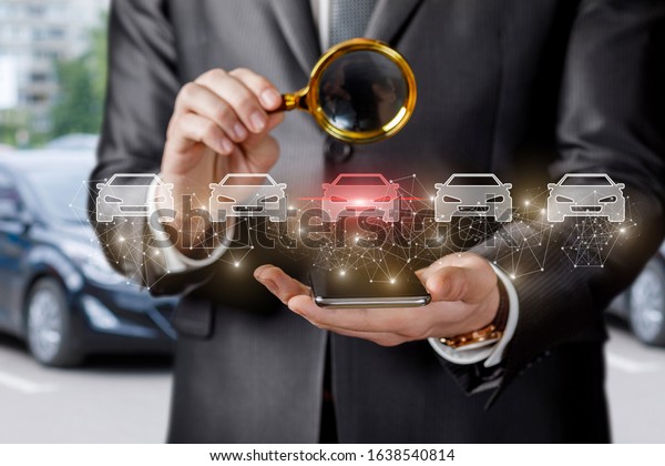Concept\
selection and inspection of a car. A businessman is looking at a\
selected car through a magnifying\
glass.