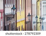 Concept: Selective focus on first street lamp only. Colored beautiful facades with street lamps in Prague Lesser Town, Czech Republic