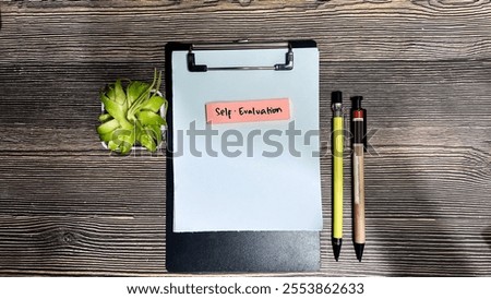 Concept of Self-Evaluation write on sticky notes isolated on Wooden Table.