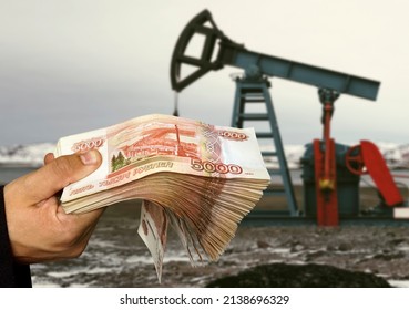 concept of selling minerals for Russian rubles. The shadow of the oil rig against the background of Russian money. Earn money from mining gas and oil energy resources - Shutterstock ID 2138696329