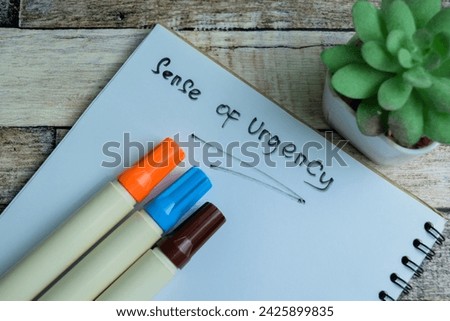 Concept of Sense of Urgency write on book isolated on Wooden Table.