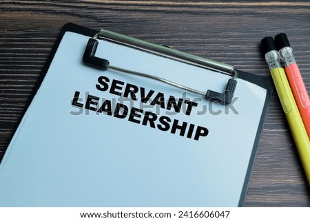 Concept of Servant Leadership write on paperwork isolated on wooden background.