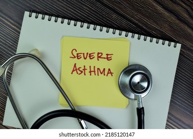 Concept Of Severe Asthma Write On Sticky Notes With Stethoscope Isolated On Wooden Table. Selective Focus On Severe Asthma Text