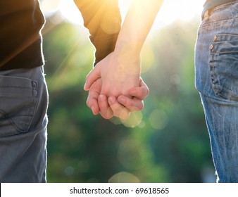 Concept Shoot Of Friendship And Love Of Man And Woman: Two Hands Over Sun Ray And Nature