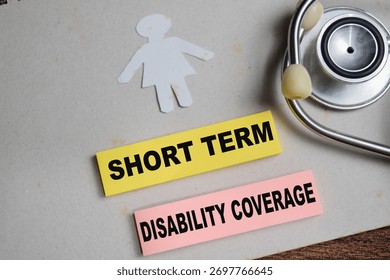 Concept of short term disability coverage write on sticky notes isolated on Wooden Table.