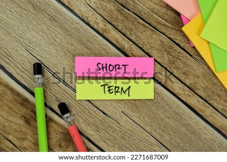 Concept of Short Term write on sticky notes isolated on Wooden Table.