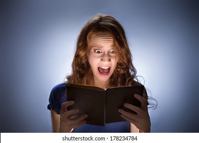 Concept Shot Of Woman Reading Horror Book And Screaming