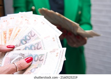 Concept showing the Croatian economy and finance. a woman wearing a green jacket is counting bills of Croatian kuna.