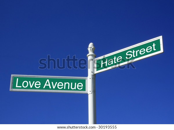 Concept sign of love or hate against a clear blue sky